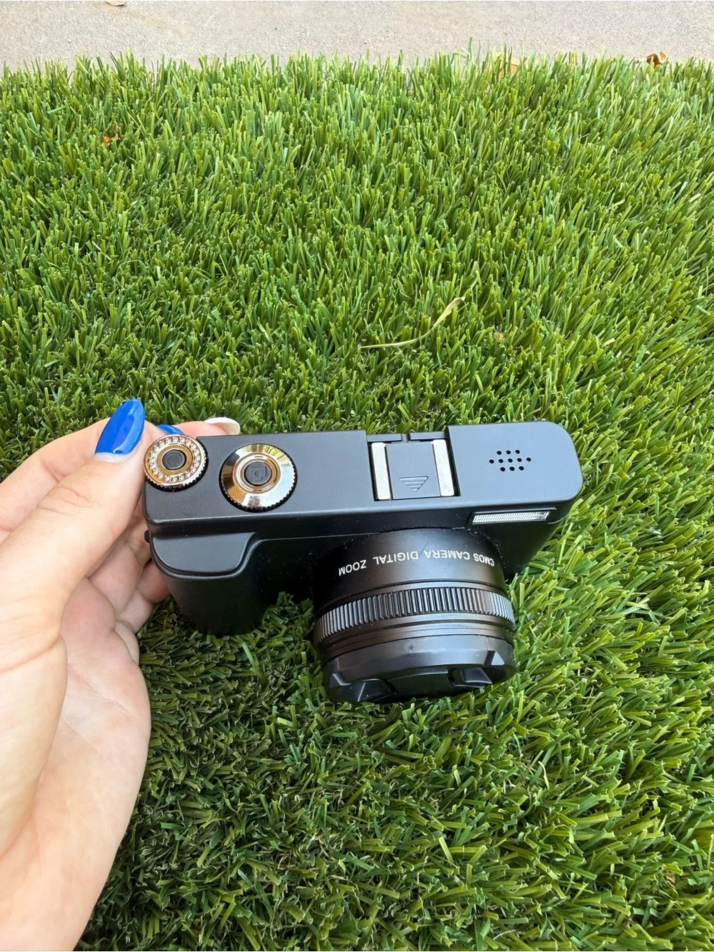 Compact Black Digital Camera with Accessories and Lens Cap